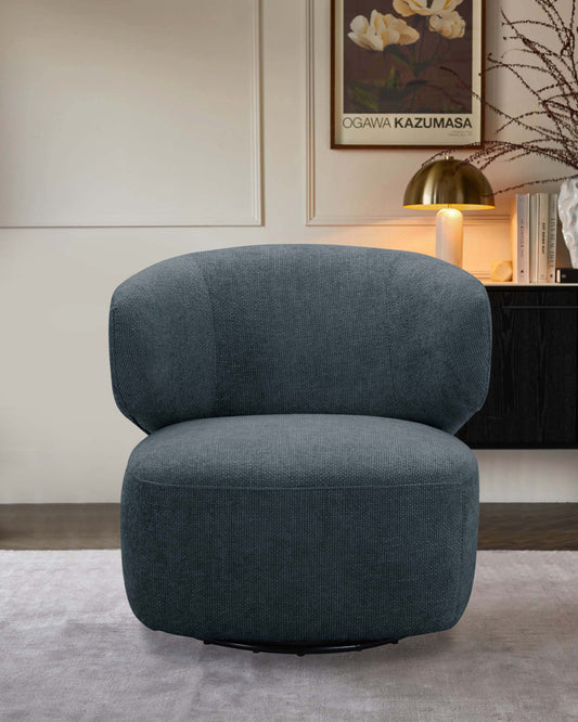 A stylish, curved green armchair with plush upholstery, set against a neutral background and accompanied by a sleek lamp.