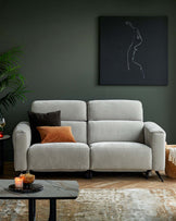 A cozy gray sofa with accent pillows, a marble coffee table, and a woven basket next to a stylized artwork on a dark wall.