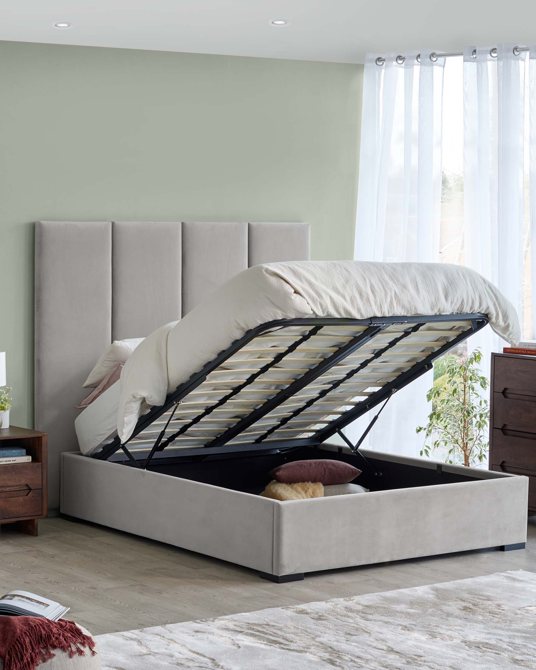 A modern upholstered bed with a hinged storage base, raised mattress, and plush headboard, complemented by wooden nightstands.