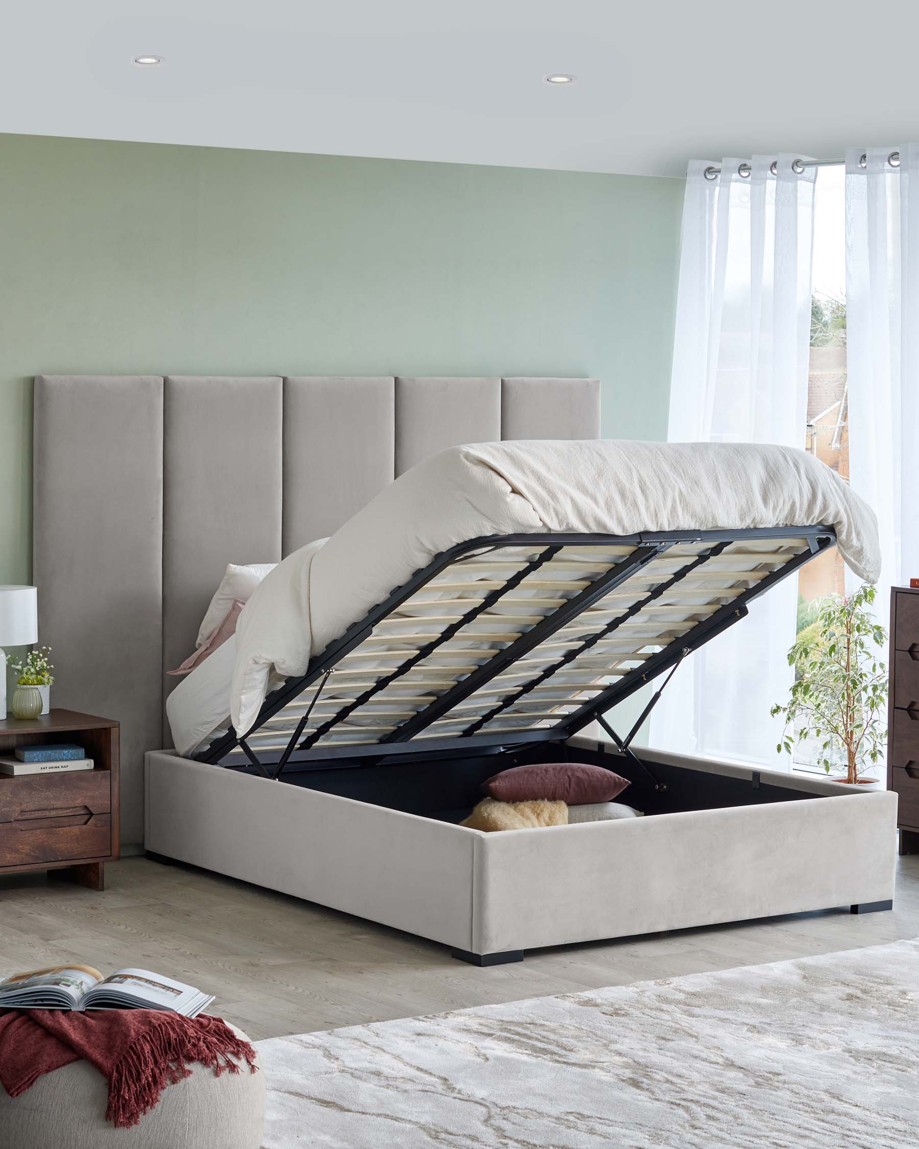 Contemporary platform bed with upholstered headboard and lift-storage base, complemented by a stylish nightstand and cozy rug.