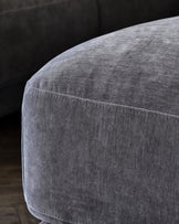 Stylish gray velvet ottoman with a soft texture and clean lines, perfect for modern living spaces and enhanced comfort.