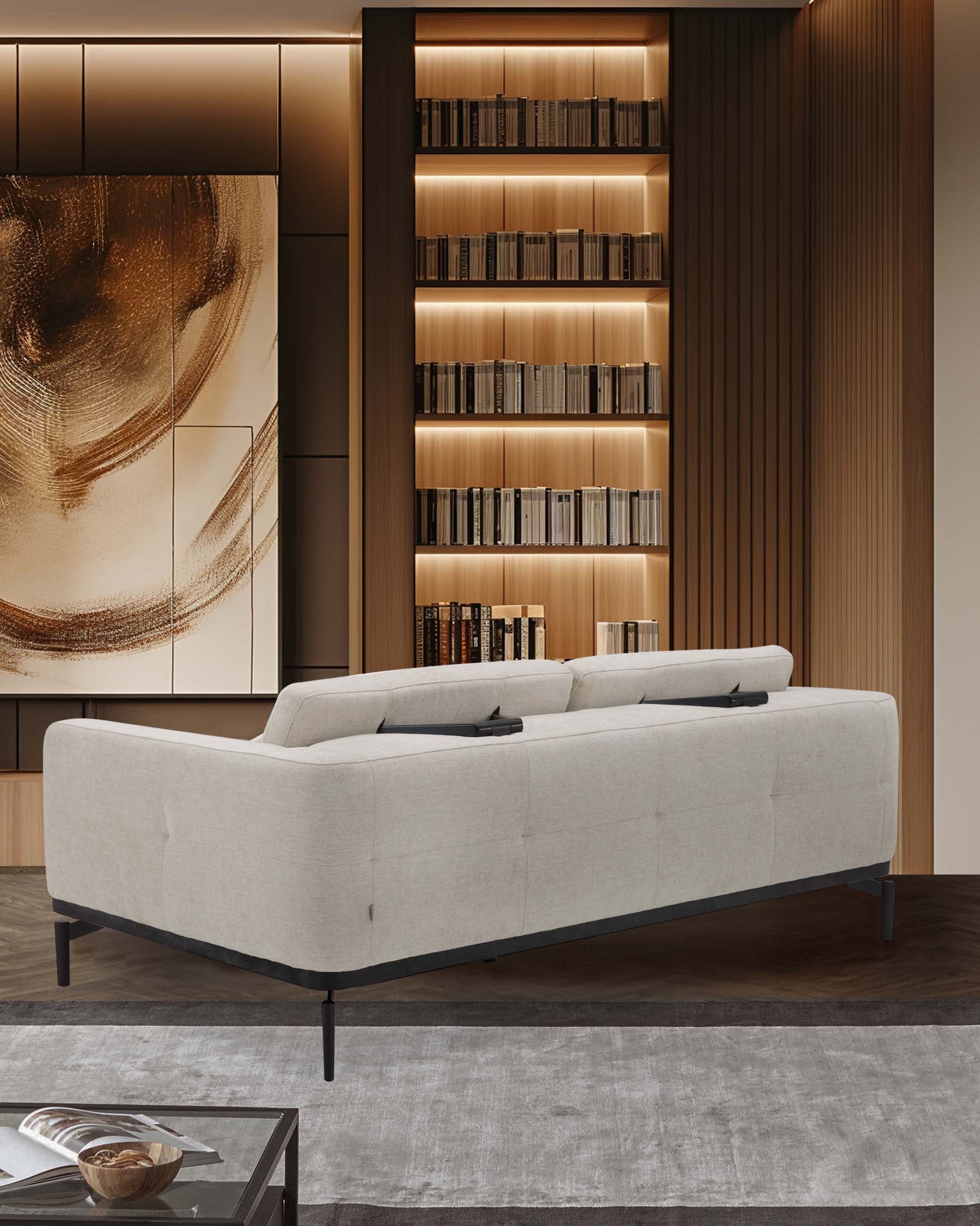 A modern beige sofa with tufted design, paired with a sleek glass coffee table and a stylish custom bookshelf.