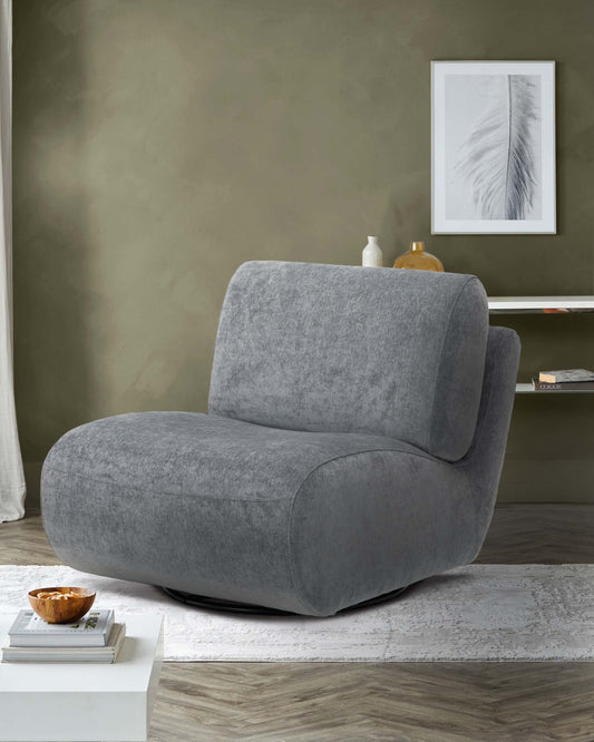 Modern grey swivel chair with plush upholstery, set on a patterned rug beside a minimalist coffee table and neutral wall decor.