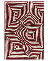 A contemporary rug featuring bold red and cream abstract patterns, characterized by flowing lines and curves.