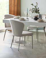 A modern dining table with a sleek design, surrounded by elegant upholstered chairs in soft tones, accented by table decor.