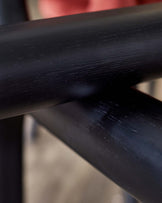 Close-up of sleek black furniture legs, showcasing a smooth finish and modern design.