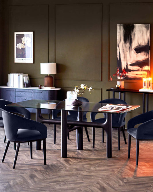 Sleek glass dining table with curved, dark wooden legs surrounded by modern upholstered chairs, highlighting elegance and comfort.