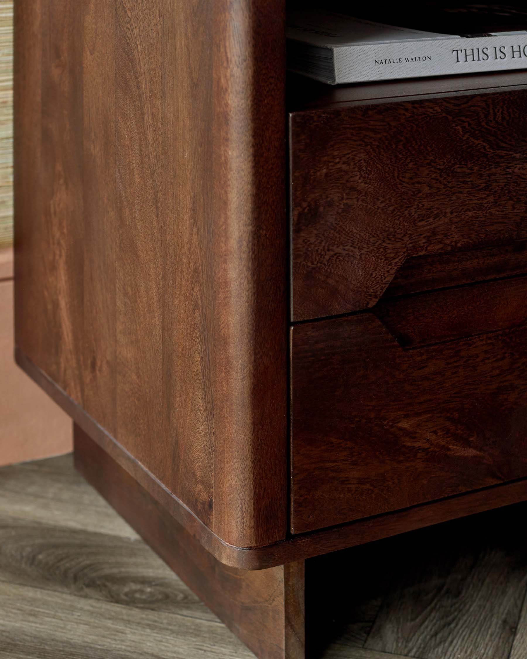 A sleek, modern wooden nightstand with a smooth finish, featuring two drawers and a stylish, rounded edge design.