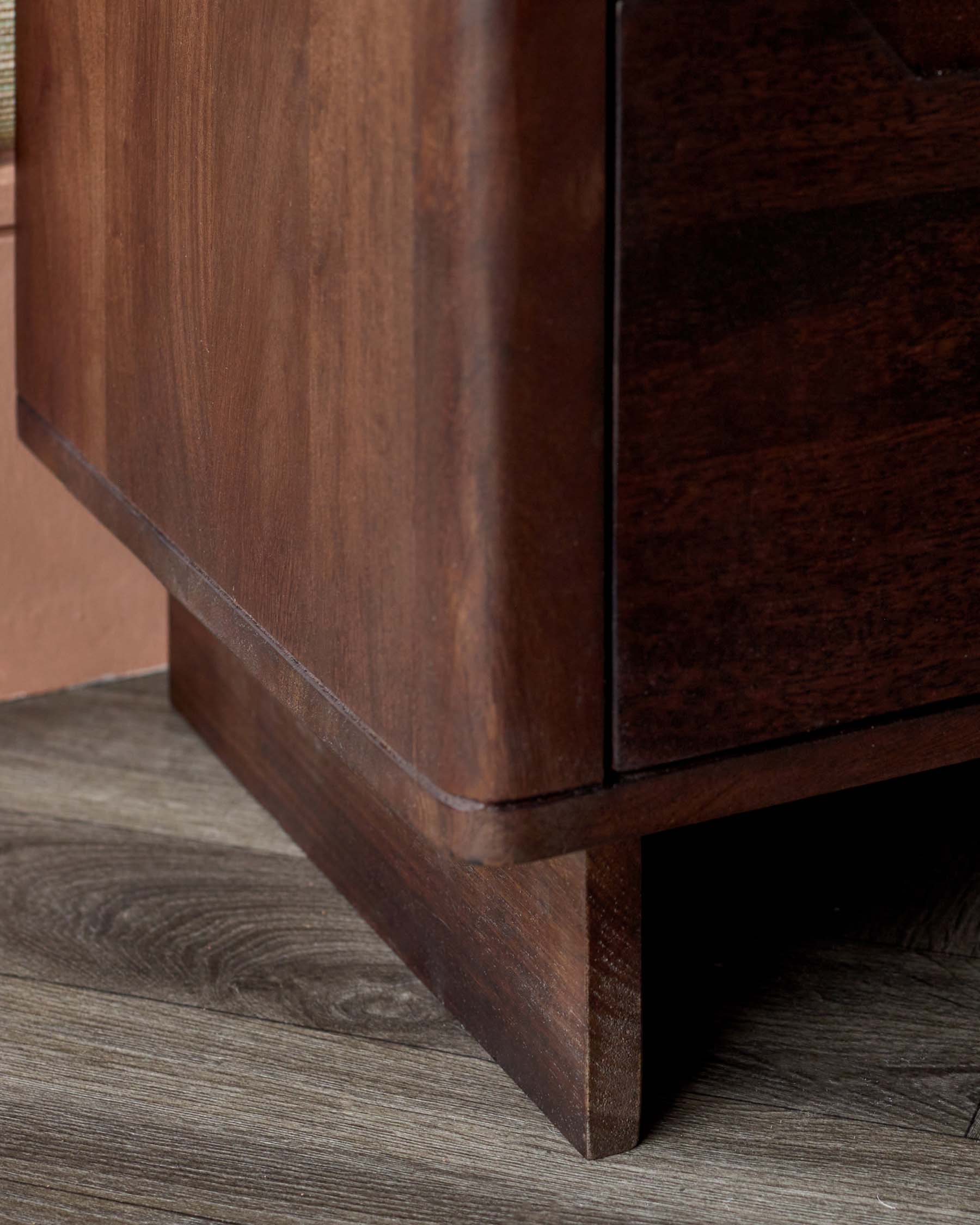 Close-up of a wooden side table showcasing a rich brown finish, sleek lines, and a sturdy, minimalist design.