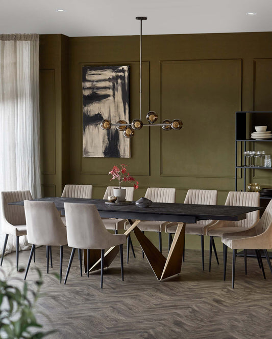 A sleek dining table with a unique base, surrounded by elegant upholstered chairs in neutral tones, and a striking pendant light above.