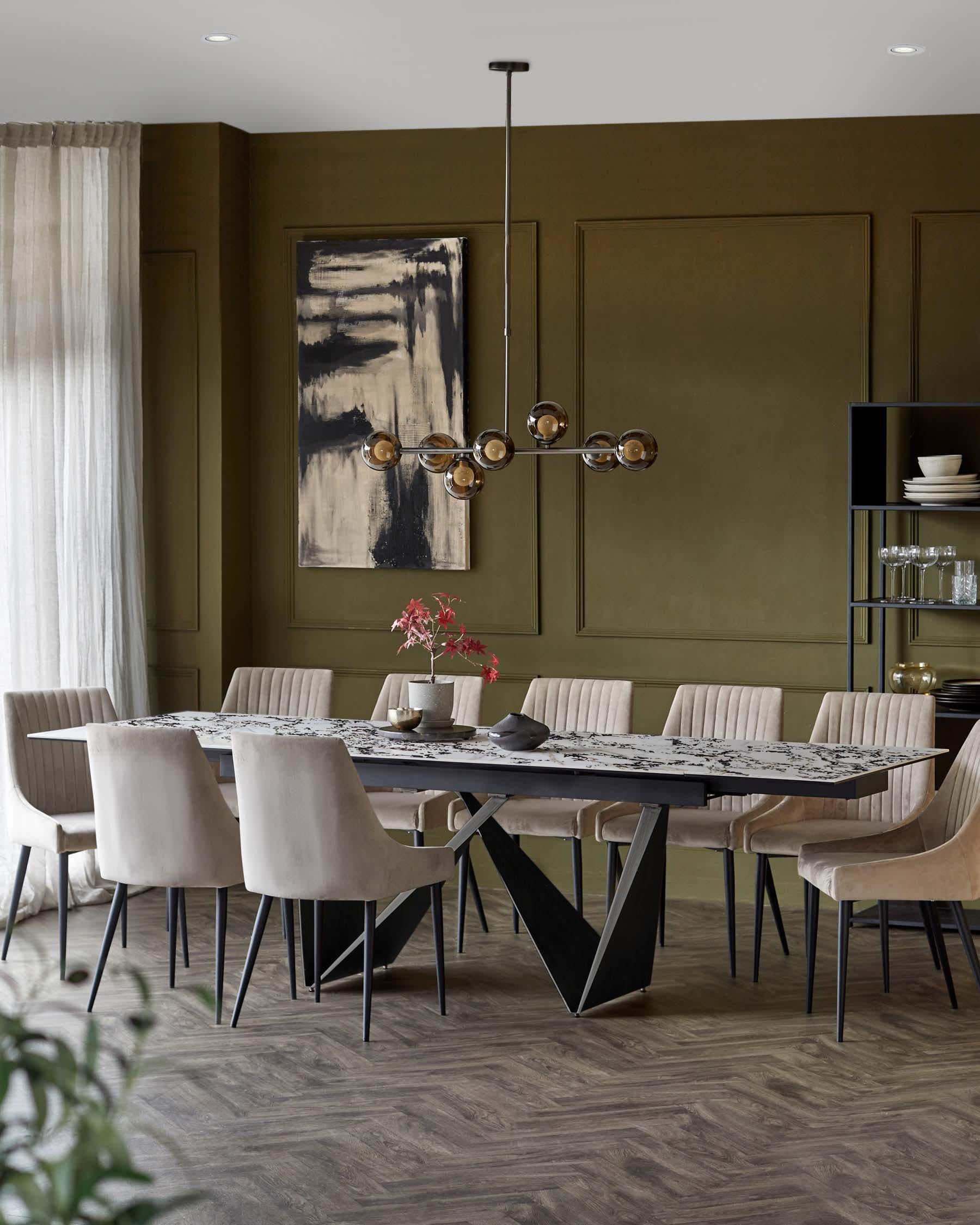 Elegant dining room featuring a marble table with an artistic black base and beige upholstered chairs, complemented by a modern chandelier.