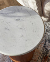 Round marble tabletop on a wooden base, elegantly designed for a modern aesthetic. Perfect for contemporary spaces.