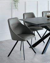 Stylish grey dining chairs with sleek black legs paired with a modern, minimalist table, enhancing contemporary elegance.