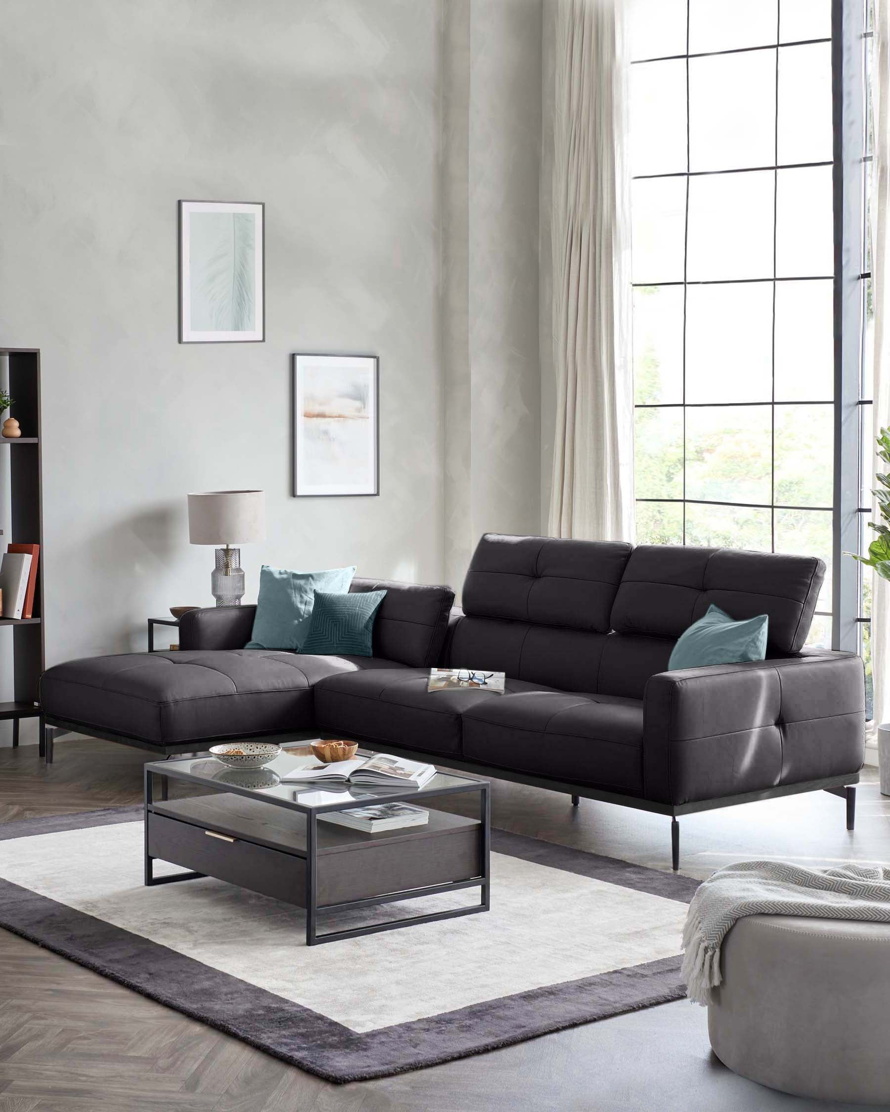 Modern black sectional sofa with teal pillows, glass-top coffee table, and plush rug in a stylish, well-lit living room.