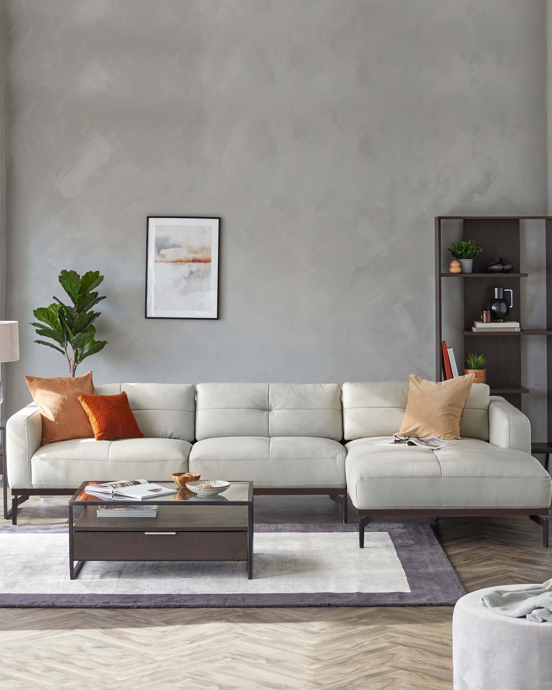 Modern light gray leather sectional sofa, glass top coffee table with a drawer, and accent pillows on a soft area rug.