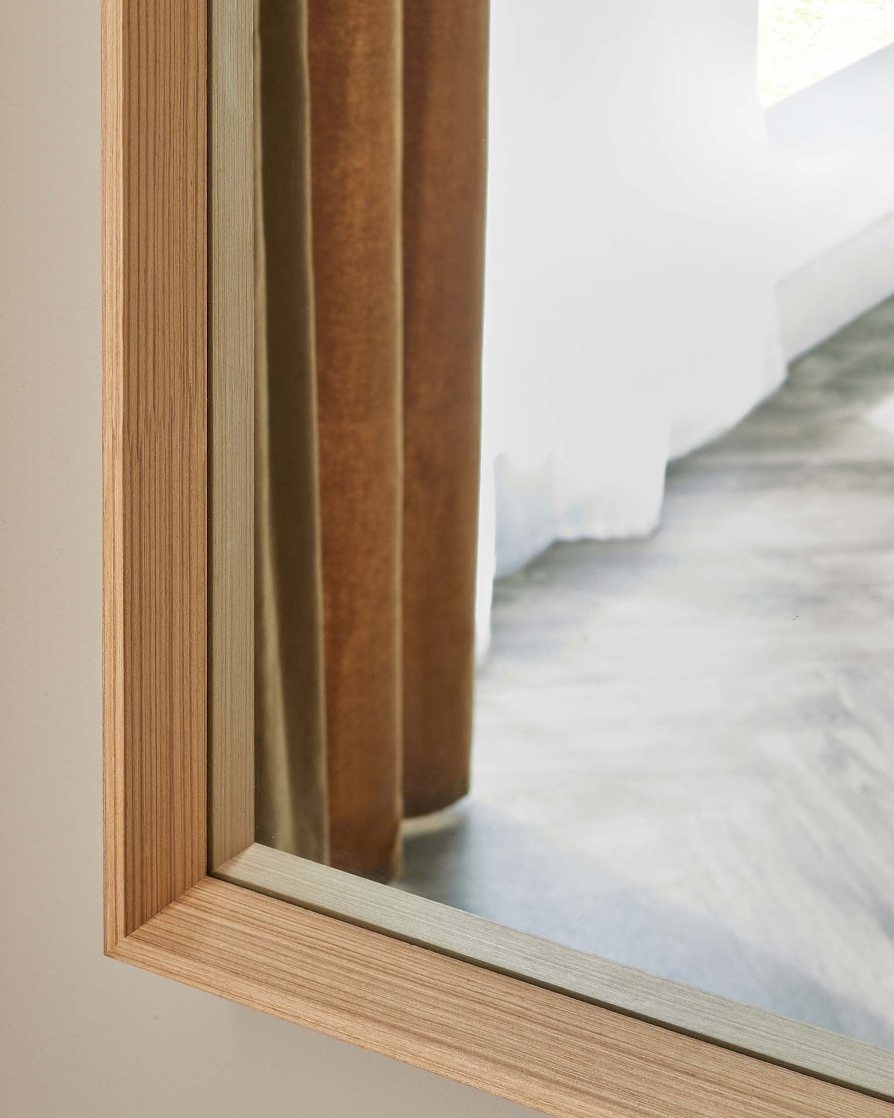 I'm sorry, but I am unable to provide image descriptions for furniture in the given picture because there is no furniture visible. The image shows a close-up of a wooden door frame with a view of a brown curtain and part of a staircase in the background.