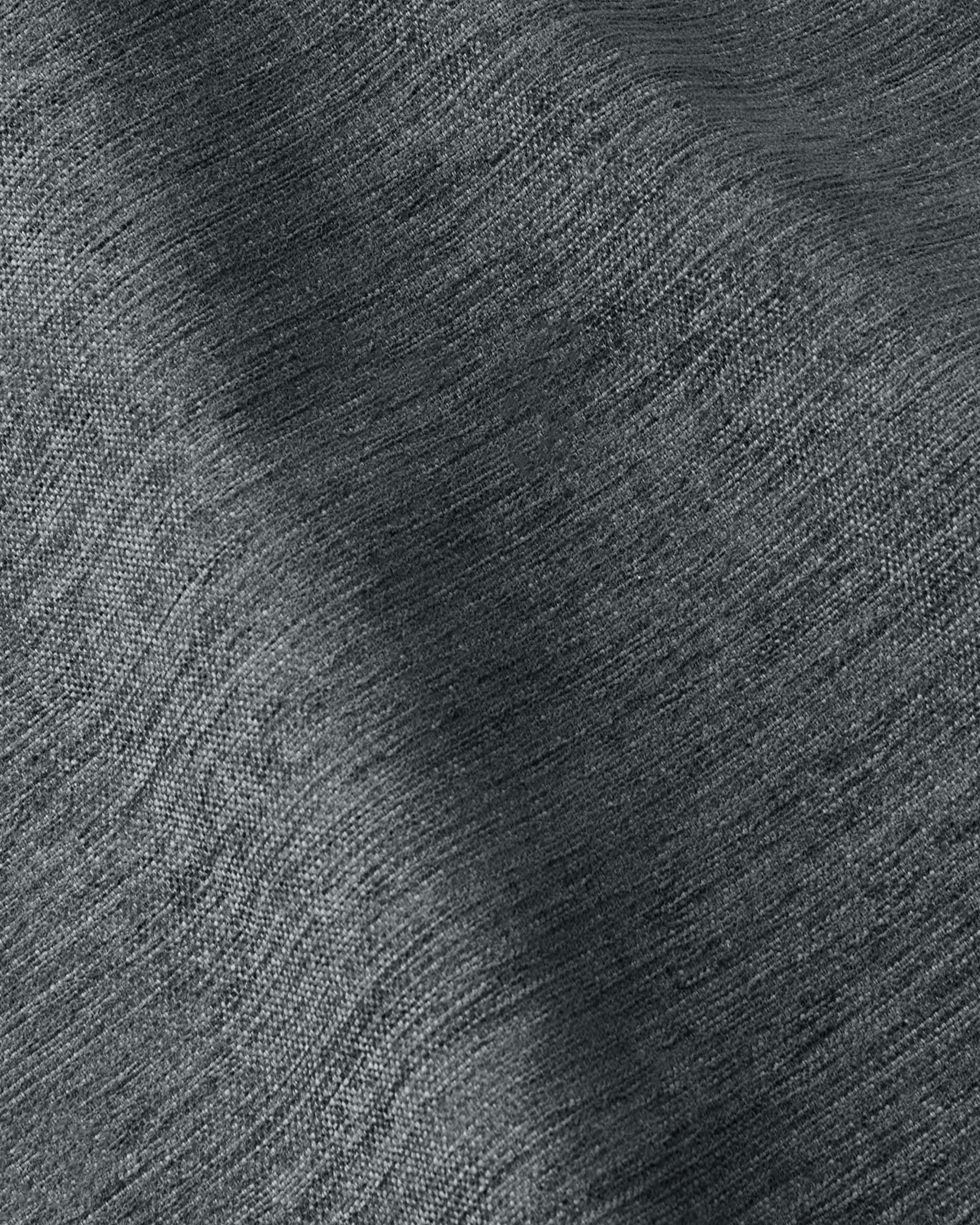 Textured dark green fabric showcasing a rich, woven pattern, perfect for upholstery or drapery in modern interiors.