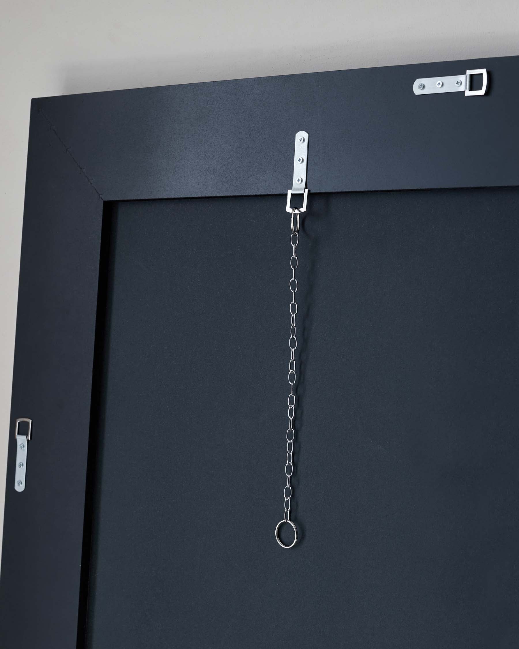 I'm sorry, but the image provided does not display any furniture. Instead, it shows a close-up of a black metal door or wall with safety chains attached through a metal bracket for security or decoration purposes.