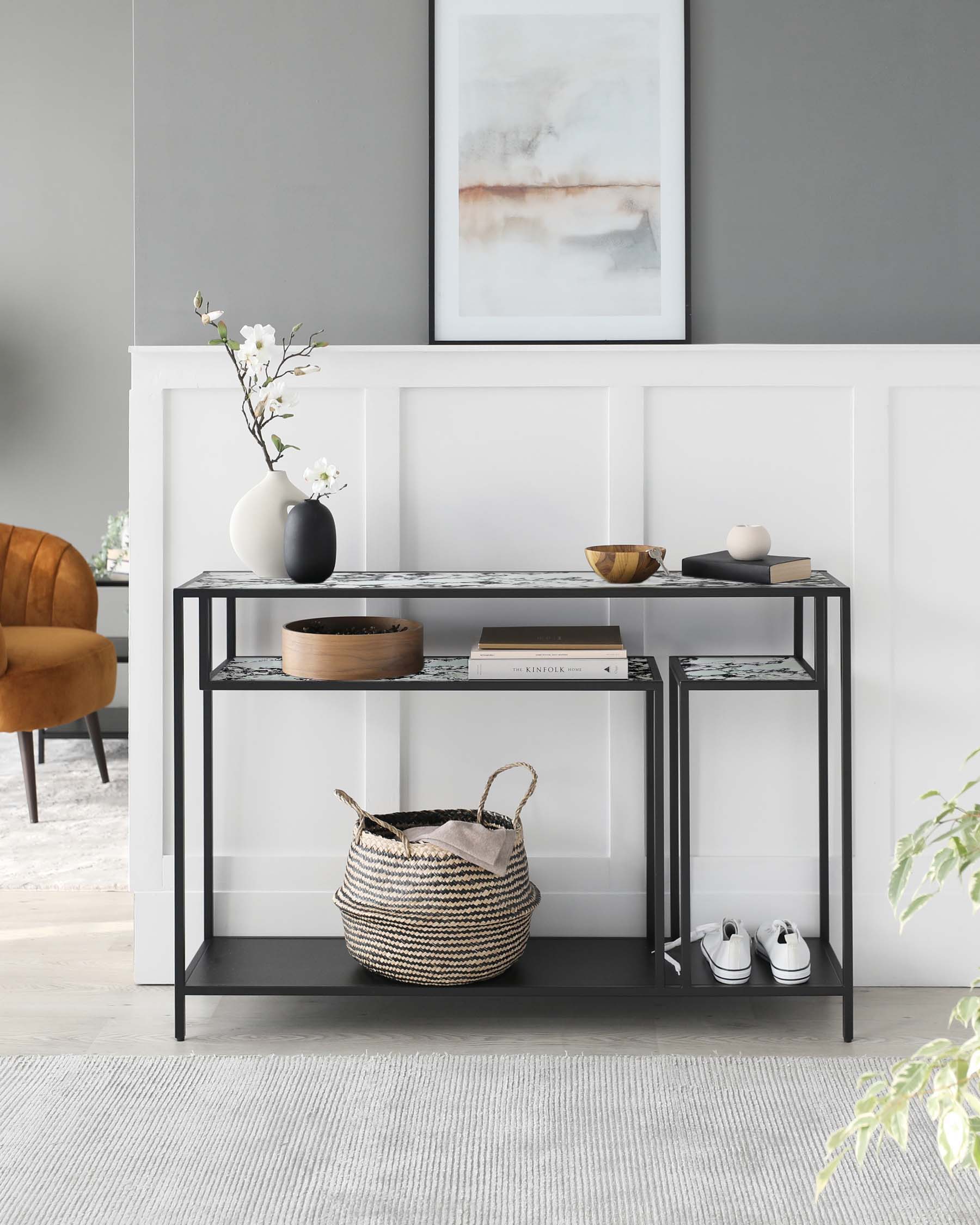 Modern console table with black metal frame, decorative items, woven basket, and stylish accents in a chic living space.