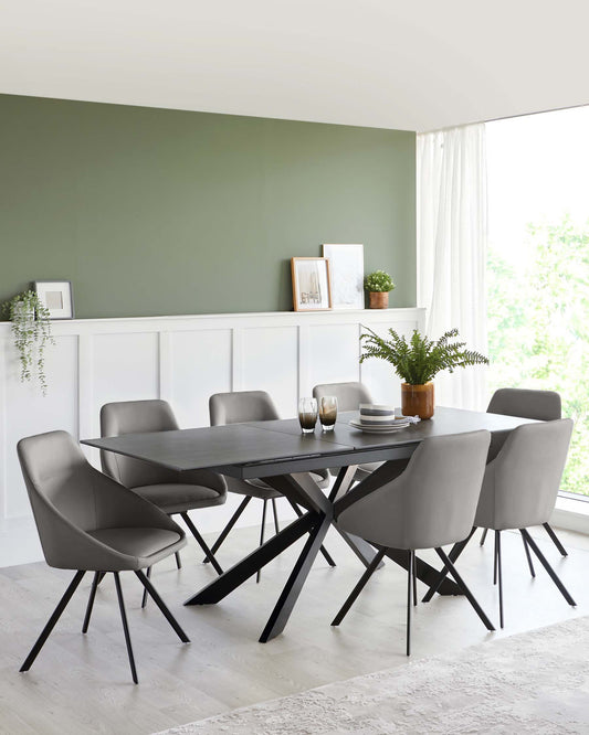 A sleek black table with angular legs surrounded by modern gray chairs, complemented by a potted plant and decorative items.