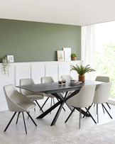 Modern dining room featuring a sleek dark wood table with angular black metal legs, complemented by six light grey upholstered chairs with slim black metal legs, set on a cream rug over a light wood floor.