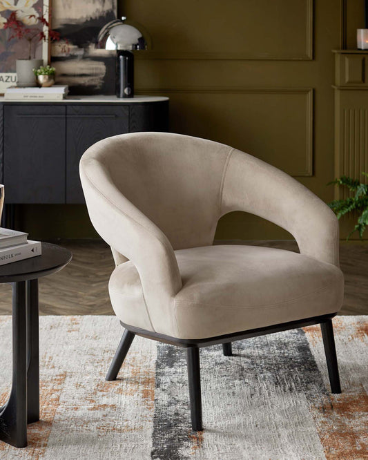 A stylish beige accent chair with a curved back, sleek wooden legs, and a cozy design, paired with a modern side table.