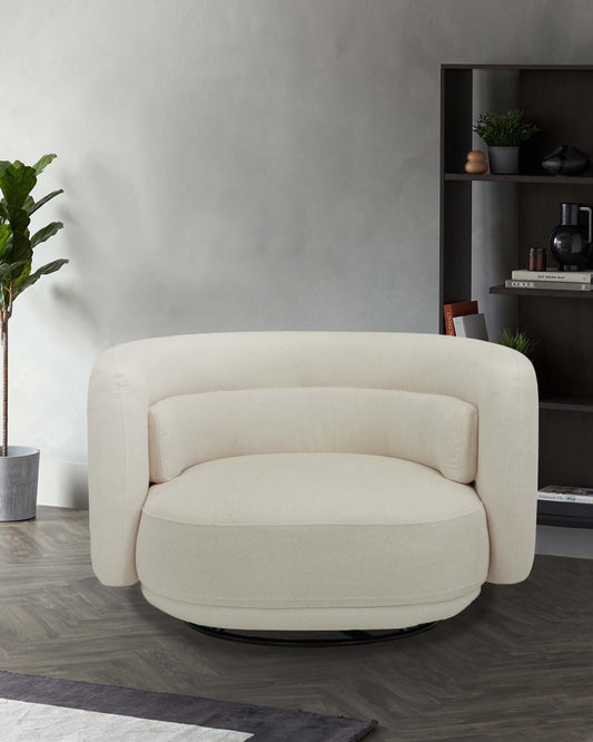 A plush, round cream chair with soft arms and a swivel base, complemented by a modern bookshelf and a decorative plant.