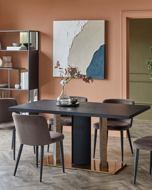 A modern dining table with a dark wood top and brass accents, surrounded by plush, upholstered chairs in a neutral tone.