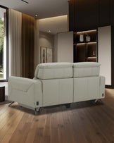 Modern beige leather recliner sofa against a stylish backdrop, featuring clean lines and subtle details, complemented by wooden flooring.