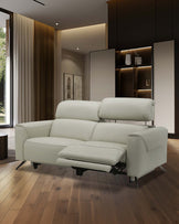 Modern light gray recliner sofa with adjustable headrests and a sleek, minimalist design, set against a stylish interior.