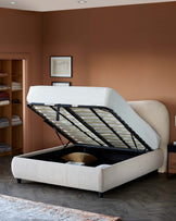 Modern upholstered bed with storage, featuring a plush fabric finish, a hinged lifting mechanism, and tapered black legs.