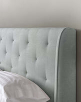 Upholstered headboard in a serene pastel colour with elegant tufting and a soft, luxurious fabric texture.