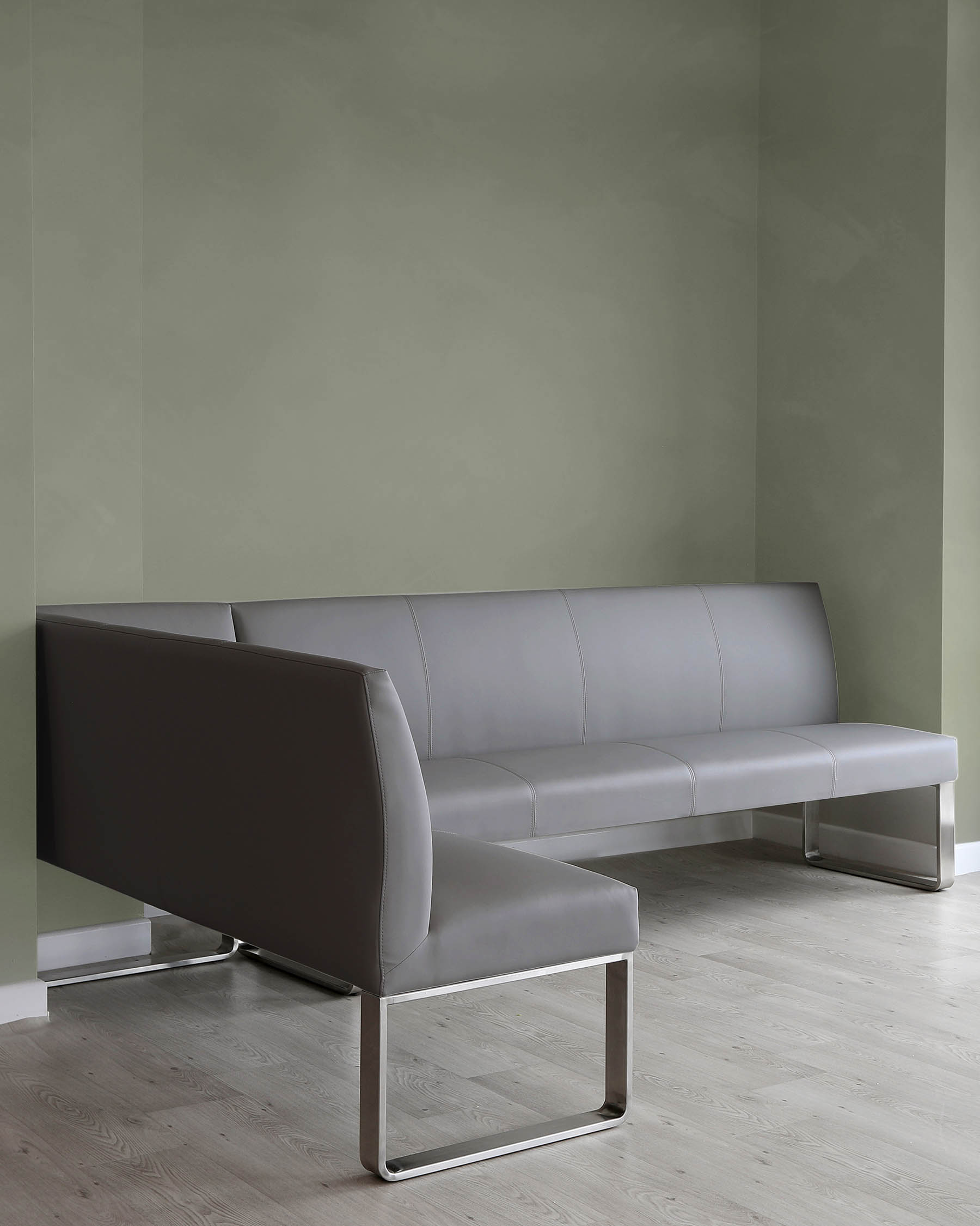 Modern grey sectional sofa with clean lines and chrome metal legs. The sofa has a streamlined design with a uniform backrest and seat cushion, emphasizing a minimalist and contemporary aesthetic.