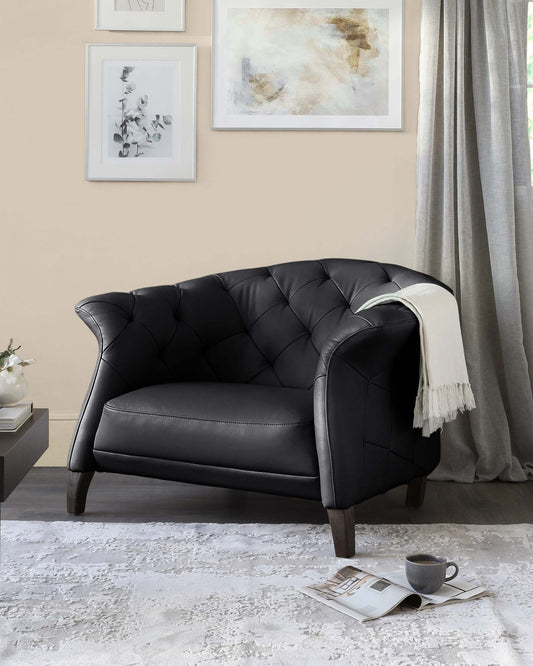 A stylish black leather armchair with tufted design, paired with a cozy throw, set on a soft rug beside a coffee cup and magazine.