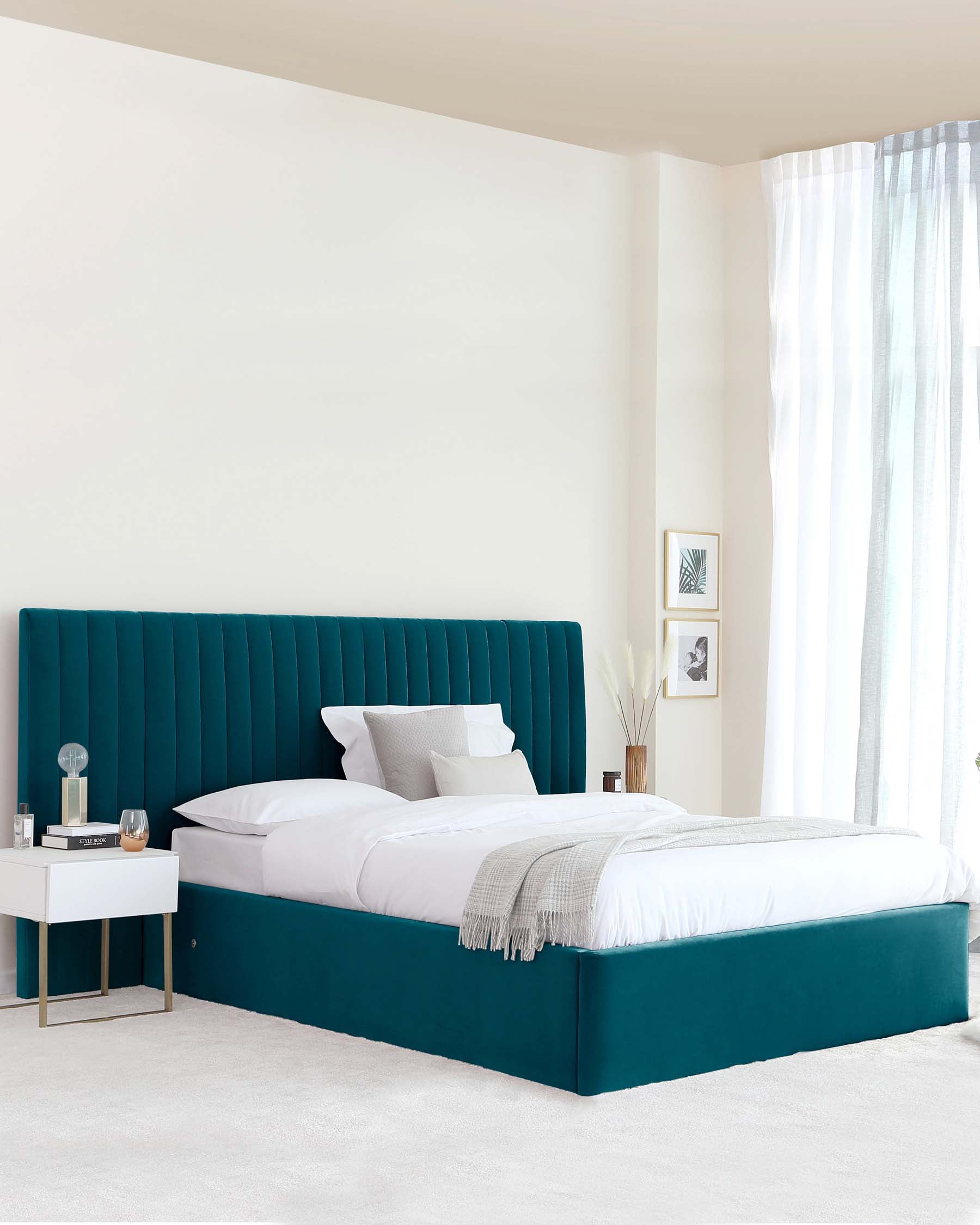 Modern teal upholstered bed with a tall, ribbed headboard and white bedding, accompanied by a sleek nightstand.