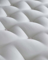 Elegant white tufted mattress with a plush, padded surface and button detailing, offering luxurious comfort and style.