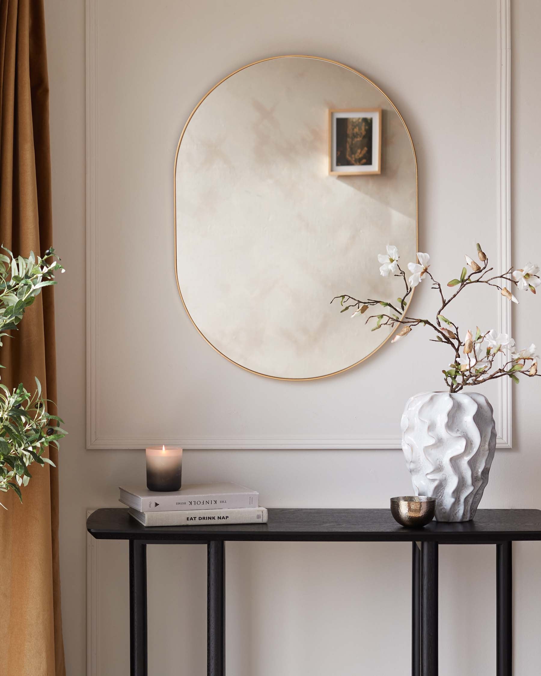 A sleek, modern black console table with a slim rectangular top and slender metal legs.