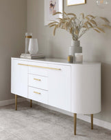 Elegant mid-century modern style white sideboard with curved edges, featuring brass-accented legs and matching brass handles on four drawers and two cupboard doors.