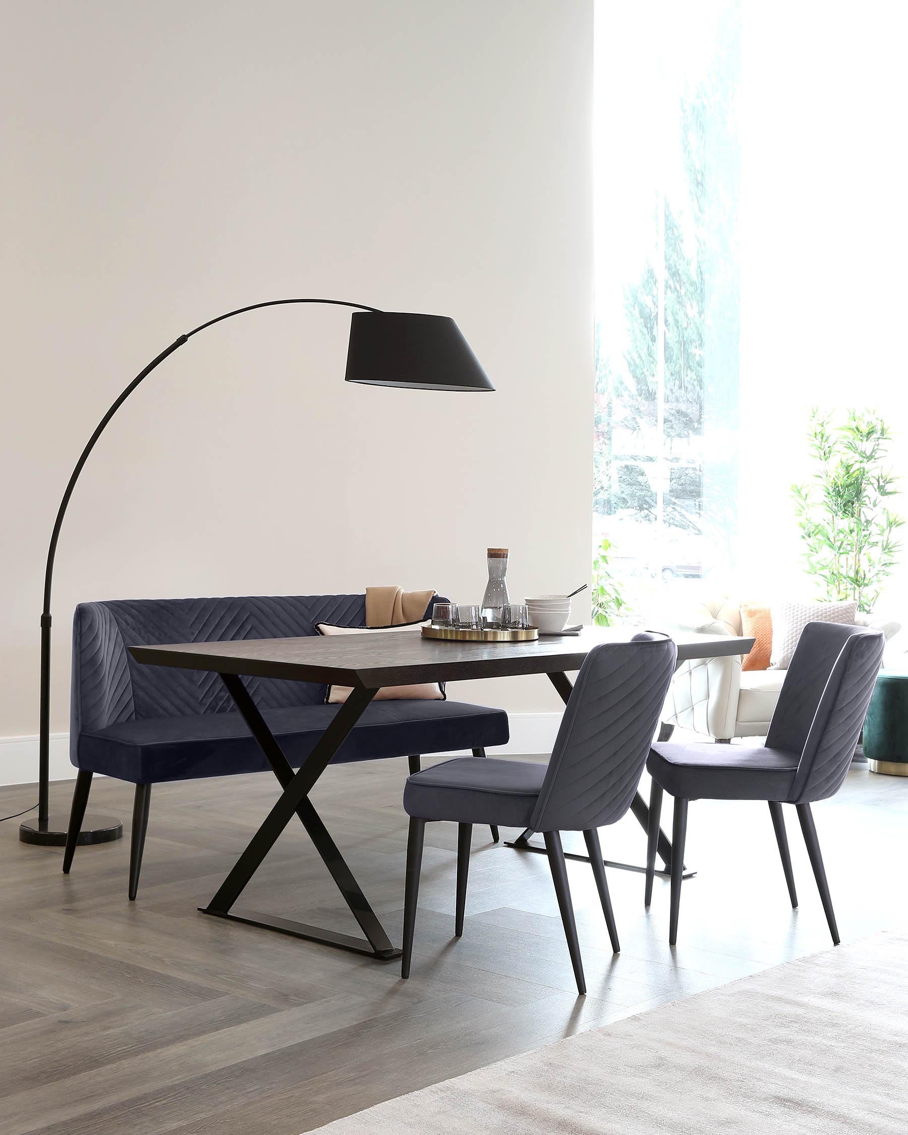 A modern dining set featuring a dark wood table with an intersecting base, accompanied by stylish navy upholstered chairs and a floor lamp.