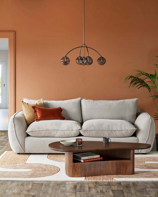 Cozy beige sofa with plush cushions, a sleek wooden coffee table, and a stylish pendant lamp above; colorful accents add warmth.