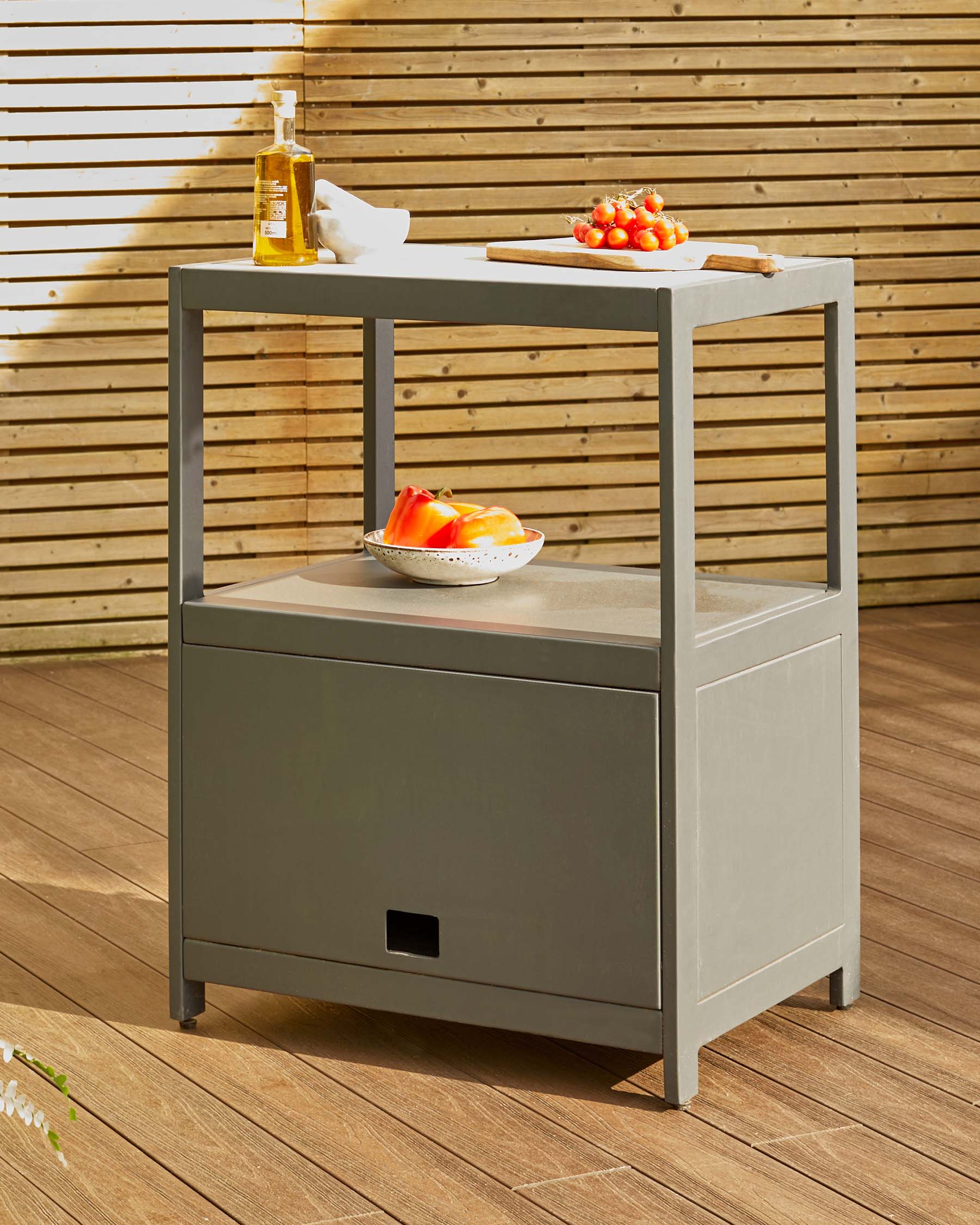 Gray outdoor kitchen cart with two shelves, featuring a top surface for prep and storage below, styled with fresh ingredients.