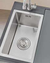 Stainless steel undermount single basin kitchen sink with modern brushed nickel faucet.