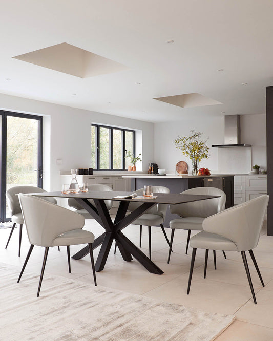 A sleek, dark wood dining table with a geometric base surrounded by elegant gray upholstered chairs. Modern and stylish.