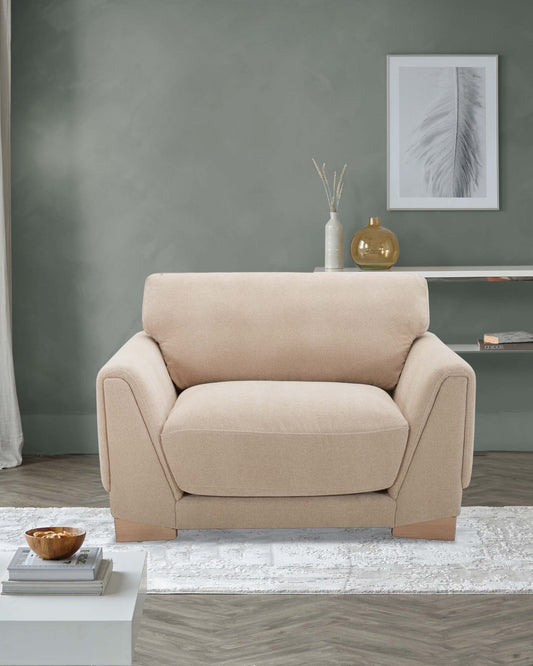 A cozy beige armchair with sleek lines, paired with a simple white coffee table and decorative vases on a light rug.