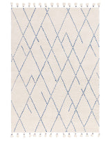 Woven area rug with a cream base and geometric diamond pattern in blue, featuring fringe tassels on the top and bottom edges.