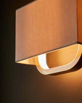 Sanza natural linen and brushed bronze wall light