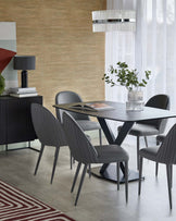 Modern dining setup featuring a sleek black table, gray ribbed chairs, a stylish lamp, and decorative plant accents.