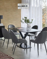 A modern dining set featuring a sleek rectangular table with a unique base, surrounded by six stylish grey upholstered chairs.