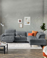 Modern gray sectional sofa with accent pillows, paired with a coffee table on a textured rug, against a muted wall with art.