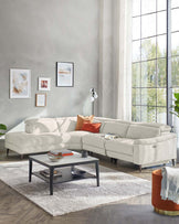 Contemporary light grey sectional sofa with chaise on the right side and a rectangular, two-tiered coffee table with a black frame and grey top, set on a textured white area rug.